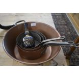 A copper preserve pan, a graduated set of three copper pans and a vintage blue glass Grand Marnier