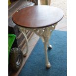 A painted cast iron terrace table with stained circular teak top