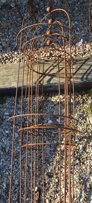 A set of four graduating ballhead garden obelisks