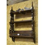 A mahogany fret cut three-tier wall shelves with two drawers to/w mahogany five division book trough