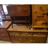 A modern stained pine chest of three long drawers with turned pulls, raised on bun feet to/w a small