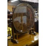 A Chinese hardwood occasional table, the circular tilt-top with carved marina scene