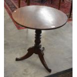 A 19th century occasional table, the circular tilt-top raised on a turned column and triform