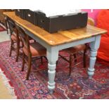 A stained pine rectangular kitchen dining table on 'duck-egg' painted base with turned supports