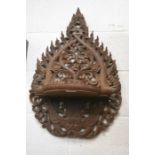 An Asian tear-drop shaped serpent carved wood panel with shelf