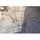 A pair of medium weathered metal circular plant frames with cast ball finials (2)