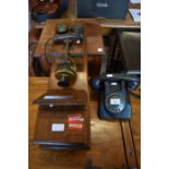 A vintage wooden cased telephone for wall mounting to/w a black Bakelite PTT dial telephone (2)