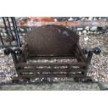 A Georgian style cast and wrought iron fire basket with arched fireback, weathered