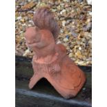 A small composite terracotta squirrel ridge tile