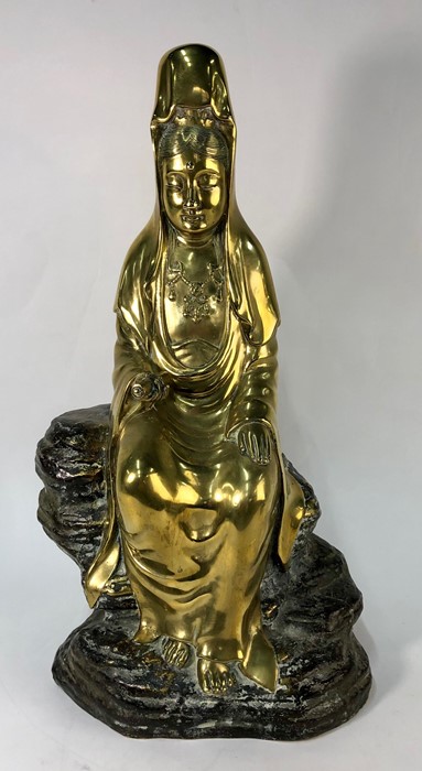 A Chinese brass figure of Guanyin