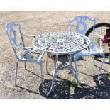 A white painted metal circular terrace table to/w a pair of painted armchairs