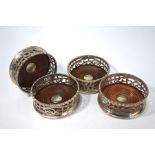 Set of four silver bottle coasters