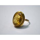 A yellow gold ring set with oval citrine