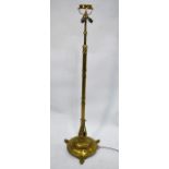 An early 20th century brass rise and fall standard lamp base