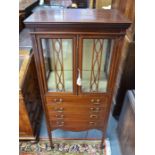 An Edwardian Shearton Revival influenced part glazed music cabinet