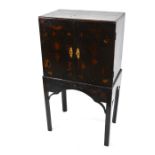 An 18th century black lacquered and decorated cabinet on stand