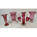 A collection of four Victorian cranberry glass vases