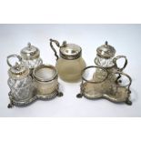 A pair of Victorian silver cruet stands, glass bottles, and mustard