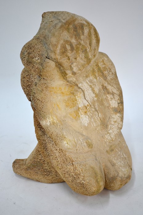 An antique Inuit carved whalebone kneeling figure