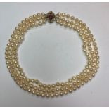 A three-row uniform cultured pearl choker necklace