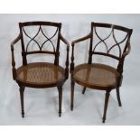 A pair of Edwardian Sheraton Revival cane seat elbow chairs