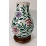 A Poole Pottery baluster vase painted with flower heads and foliage