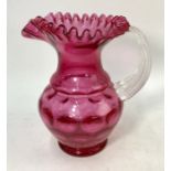 A large Victorian cranberry glass water jug