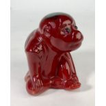 A Bernard Moore flambe glazed model of a seated monkey