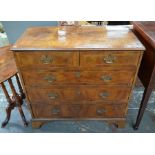 An 18th century feather-banded walnut chest of two short over three long graduated drawers