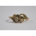 A 9ct yellow gold ring decorated with two conjoined hearts