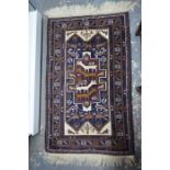 A Persian Balouch rug, the navy field decorated with various stylised animals
