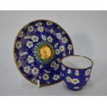 A Chinese Canton enameled tea bowl and saucer