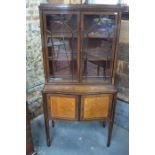 A late 19th century ebony banded and inlaid flame mahogany library cabinet of serpentine form