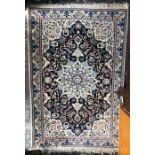A Persian Nain rug, the traditional geometric centre medallion design in blues on ivory ground