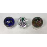 Three Selkirk glass paperweights