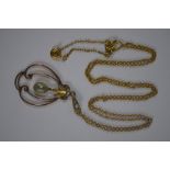 An Art Nouveau pendant set peridot and pearl