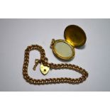 A 9ct yellow gold curb chain and oval locket