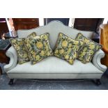 A Queen Anne style hump back sofa with scroll arms