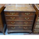 A Georgian oak chest of two short over three long graduated drawers