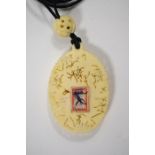 An early 20th century Japanese carved ivory floral pendant