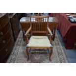 An early 20th century American walnut 'Grille-back' carver/armchair