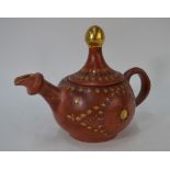 A Turkish terracotta teapot and cover