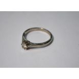 An 18ct white gold ring set with single claw set brilliant cut diamond