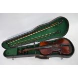 A vintage violin, bears label for Giuseppe Guarnerius, 60 cm long