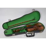 A vintage children's violin, 42 cm long to/with a bow in a fitted case