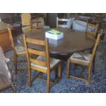 A large oak pedestal dining table, the circular top with moulded edge raised on a turned column