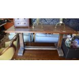 An Arts & Crafts style rectangular oak occasional table with chamfered square supports
