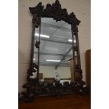 A large Rococo Revival walnut overmantel mirror