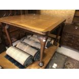 An old mahogany draw-leaf dining table raised on club legs