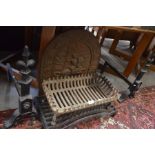 A heavy cast iron fire back with pictorial frontage, a fire grate and rests, to/w a log rest